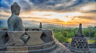 A sunset view of the ancient Borobudur temple complex in Central Java