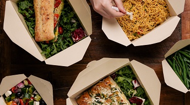 Variety of foods in takeout boxes