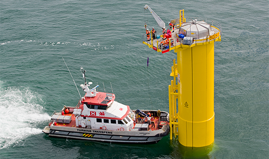 boat docked at the building of the Gemini Project offshore wind farm