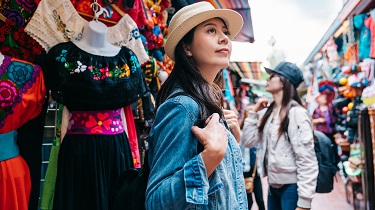 Women wearing masks browse Mexican market