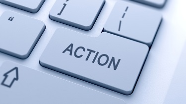 Image of a white keyboard with the word Action in black all caps on the return key