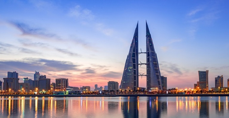 The sun sets on the distinctive skyline of Manama in Bahrain.