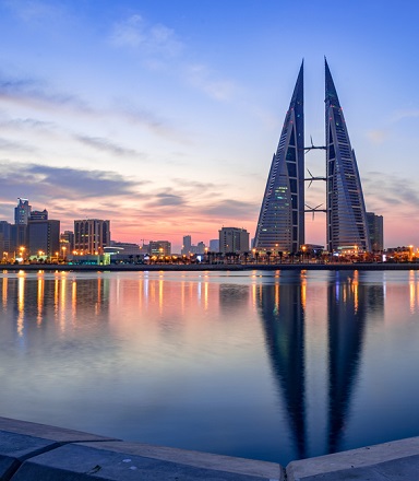 The sun sets on the distinctive skyline of Manama in Bahrain.