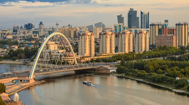 The skyline of Astana, Kazakhstan at dusk.