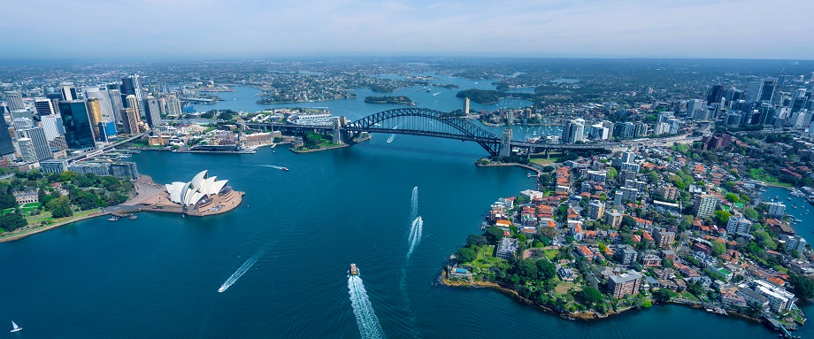 View of Sydney, Australia’s opera house, Sydney Harbour Bridge, boats, buildings, waterway