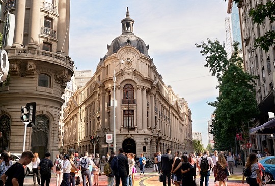 A crowd walks through the historic city of Santiago, Chile.