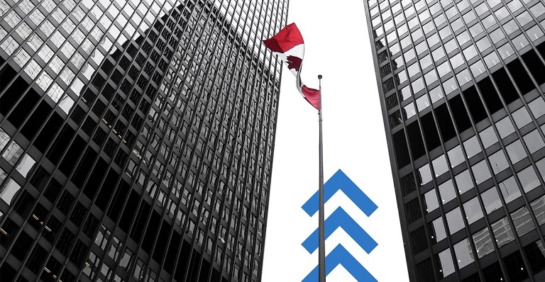 The Canadian flag waves in front of a tall office building