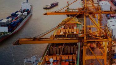 Shipping containers at a port where supply chain disruption is a risk.