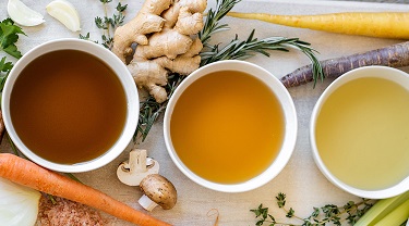 Bowls of delicious soup are served on a platter.