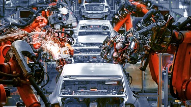 Automobiles being built in a factory.