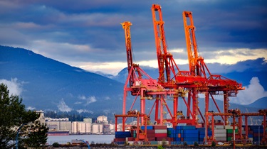 Three cranes for loading shipping containers in a port