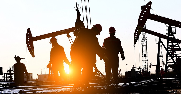 Oil workers work on rig
