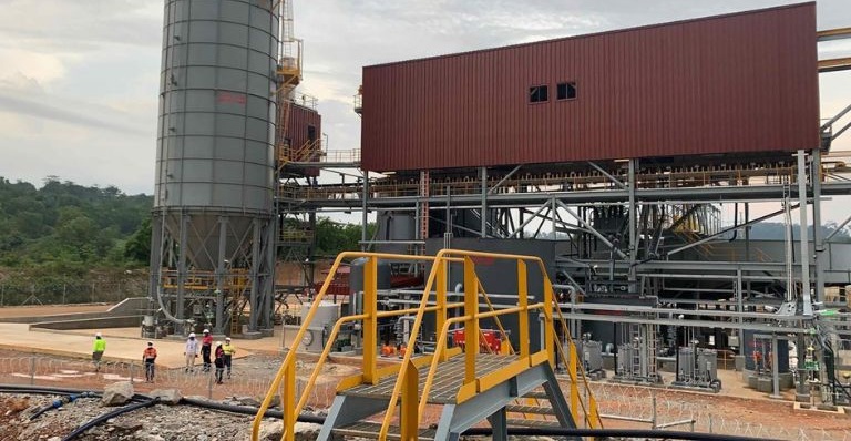 Exterior view of CEC’s integrated plant with workers in safety vests and helmets.