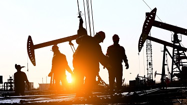 Oil workers work on oil-patch rig