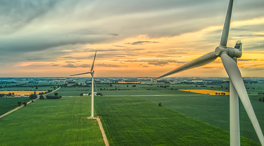 Image of wind turbines at sunset