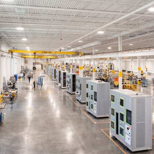 Rows of thermal management systems equipment on a manufacturing facility floor.