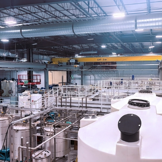 Industrial facility with large tanks, piping and processing equipment.