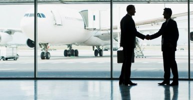 Des hommes d’affaires se serrent la main à la suite d’une rencontre dans un aéroport