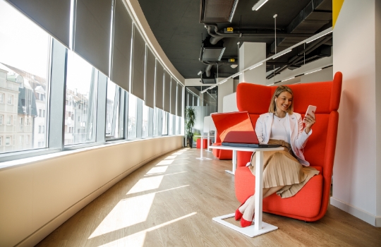 A woman having a video call in coworking office space.