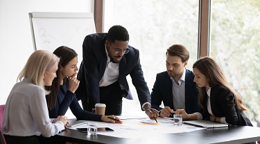 Five executives meet to discuss business.