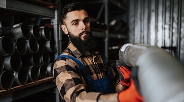 Exporter works in his vehicle spare parts warehouse.