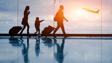 Silhouette of young family and airplane.