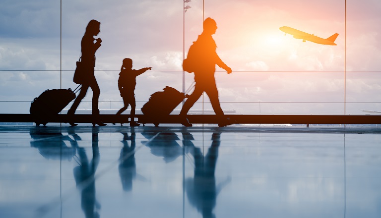 Silhouette of young family and airplane.