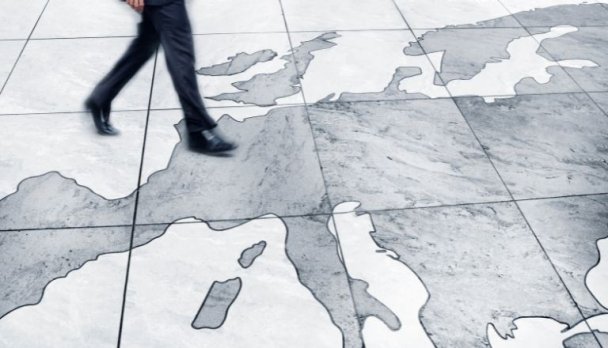 Man walking on floor map of Europe.