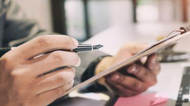 A clipboard and pen show that following trade compliance rules is a part of doing business in the United States.