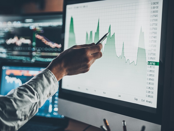 Businessman points to data in chart with pen