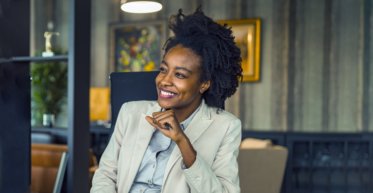Beautiful black female business owner smiles in boardroom