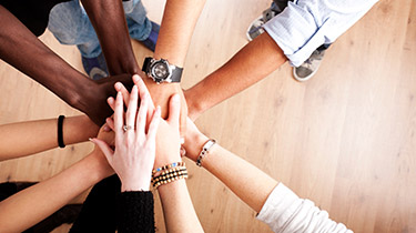 Image of diverse hands and genders to represent strategic guidance on ESG topics