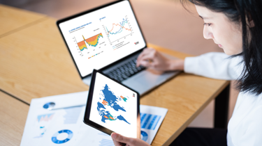 Business woman looking at data reports.