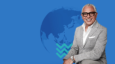 Joseph Mimran poses with globe.