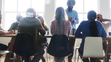 A group of young executives meet to discuss how to lead a complex workforce internationally