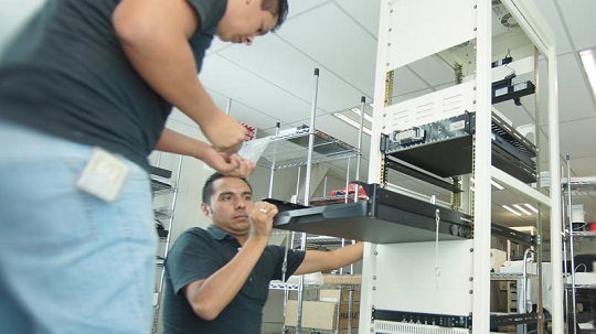 Averna employees working on their technology equipment.