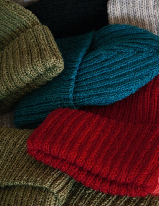 An array of wool hats are ready for shipping.