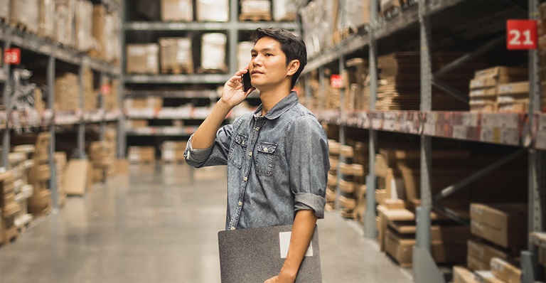Portait of a man checking stock of products in warehouse
