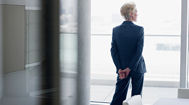 Businesswoman standing at window in office