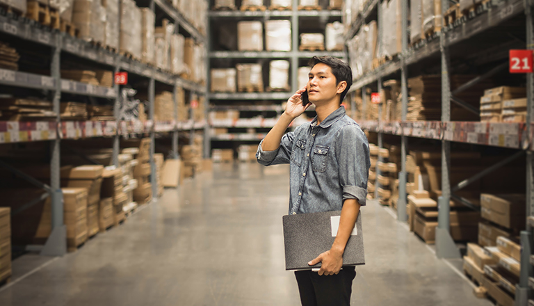 Portait of a man checking stock of products in warehouse