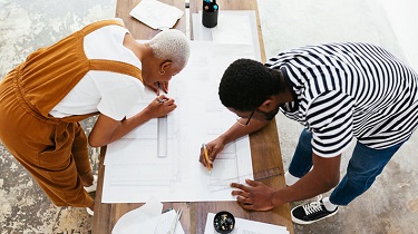 Image of two people working in a business representing inclusive trade.