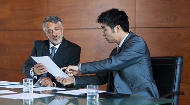 Two businessmen sign a contract 