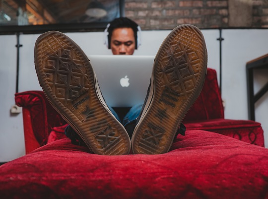 Man working on his computer in bed