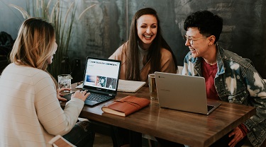 Three co-workers laughing