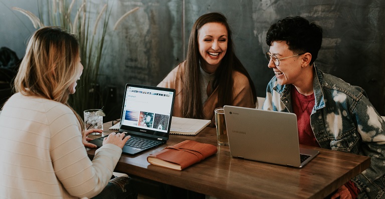 Three co-workers laughing