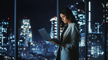 A woman looks at her laptop.