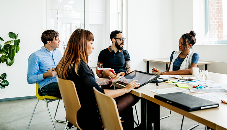 A small business advisory board meets in a conference room