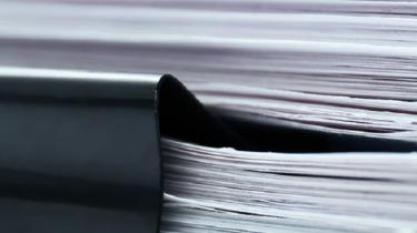 Stack of papers shows there are many resources to help exporters find international business partners to be competitive