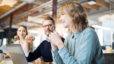 Image of people talking at a table to represent EDC’s engagement with stakeholder groups