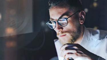 Canada needs highly skilled tech talent, like this person in the glow of a computer screen